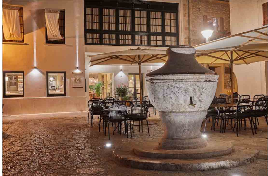 Chairs and tables outside at night at the Mon Boutique hotel in Spain.