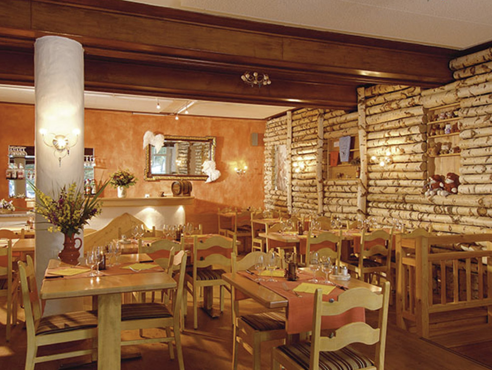 hotel dining area with wall made of small tree logs