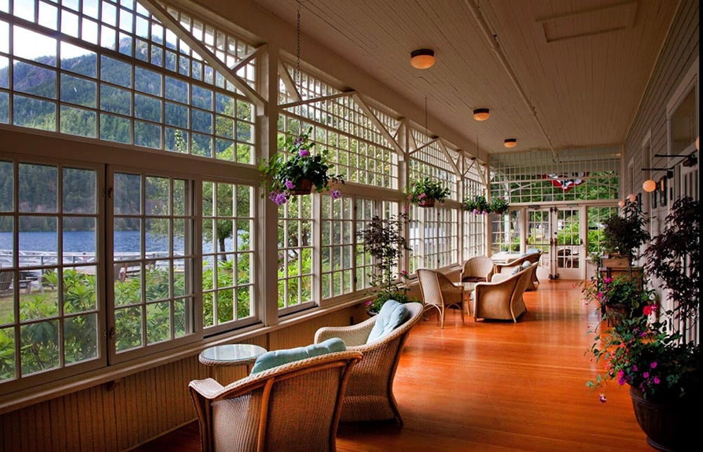 Lake Crescent Lodge porch looking onto a lake with hill in background