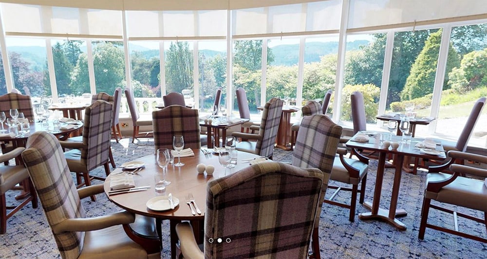 hotel dining area with large windows looking out onto valley forest