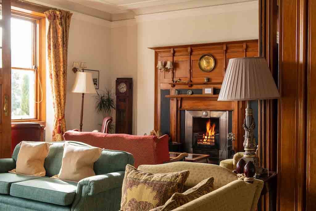 Lounge with fireplace at the Lovat Loch Ness hotel in Scotland