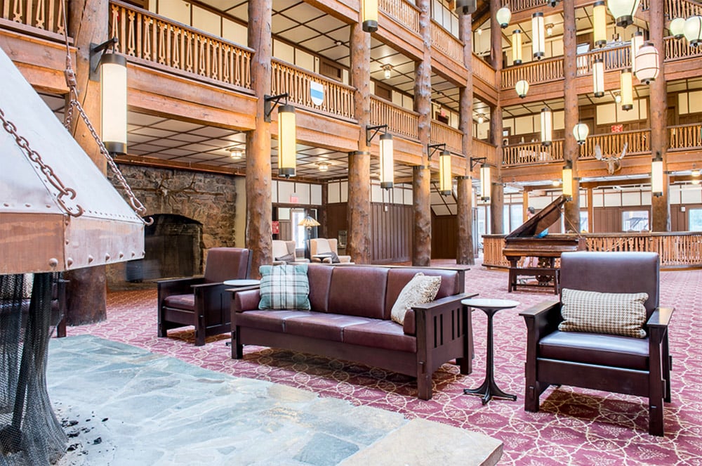 spacious Glacier Lodge lobby area with moose head hanging on wall in the background