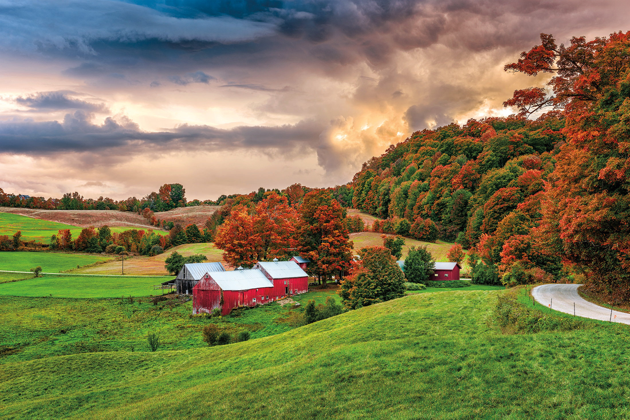 Scenic fall foliage scene with red barn in Vermont