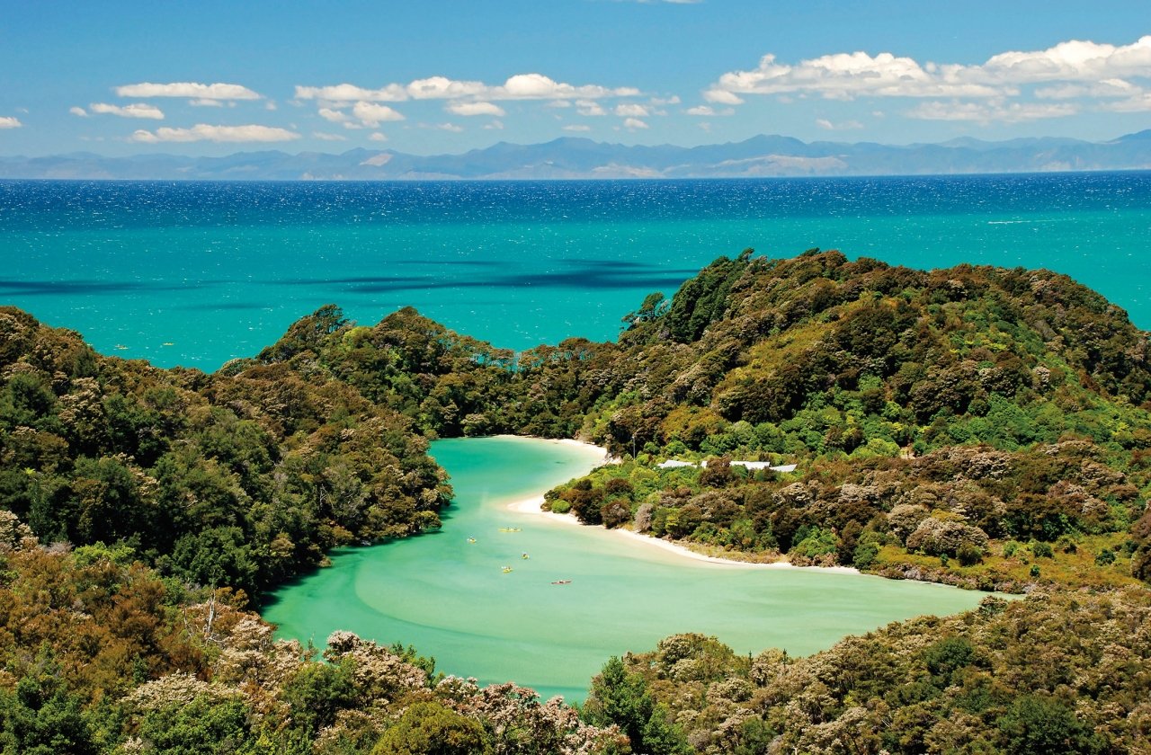 Mountains surrounding a lake next to the ocean