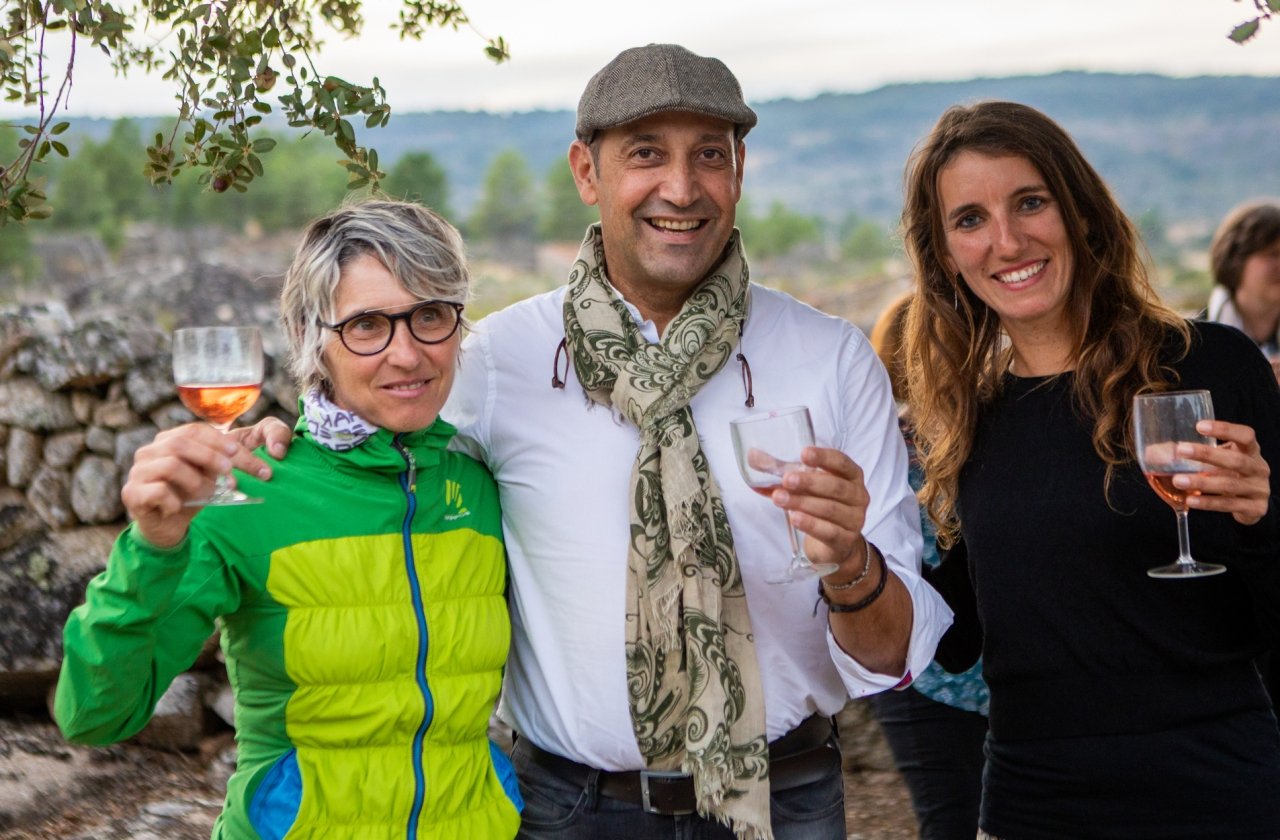 Three people posing with their wine glasses