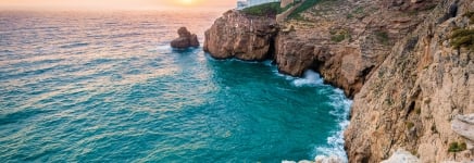 Coastal view with lighthouse in the distance in Lisbon, Portugal