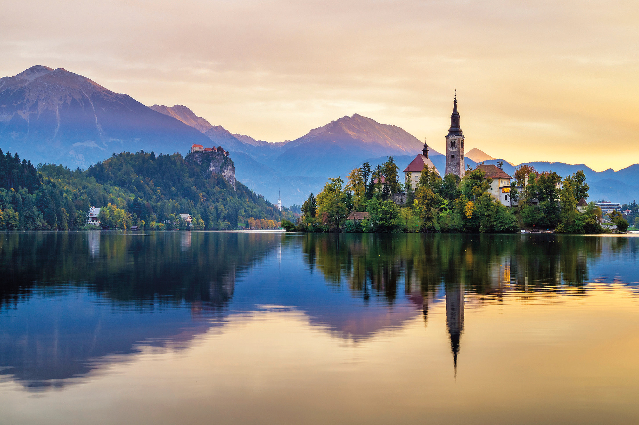 Sunrise over lake Bled in Slovenia with mountains in the background